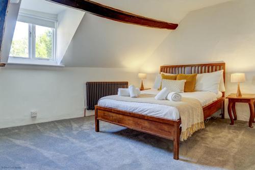 a bedroom with a bed with two lamps and a window at Market Place Cottage in Woodstock