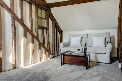 a living room with a white couch and a table at Market Place Cottage in Woodstock