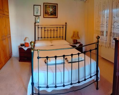 a bedroom with a bed with a metal frame at Seaside Pool Villa in Mesongi
