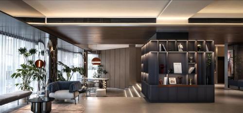 a living room with a shelf with vases on it at Holiday Inn Express Shanghai Jing'an Temple by IHG in Shanghai