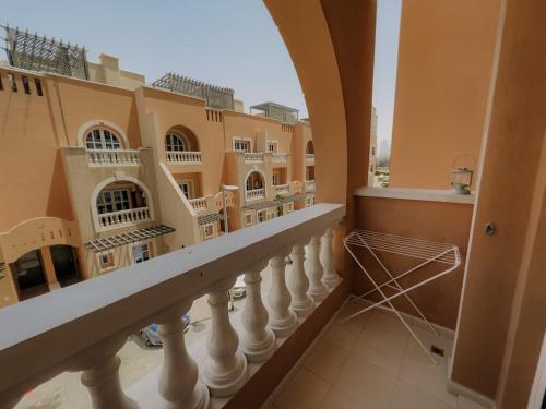 a balcony with a view of a building at Free housekeeping visits during your stay - StayShort - Cozy 1-Bedroom Apartment in Summer Residences JVC in Dubai