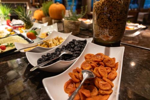 a table topped with bowls of dried fruits and nuts at Hotel Balnea Superior - Terme Krka in Dolenjske Toplice