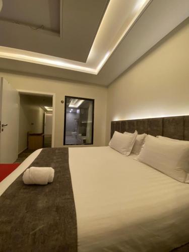 a bedroom with a large bed with white pillows at Golden New Tulip Abha in Abha