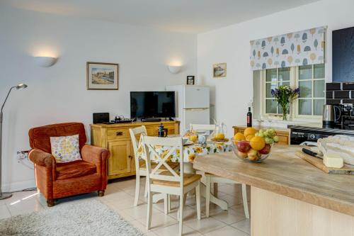 a kitchen and dining room with a table and chairs at Station Cottage in Long Hanborough