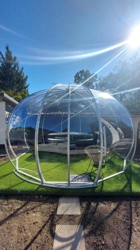 a dome house is sitting on the grass at Családi kikötő apartman in Gyula