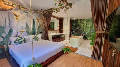 a bedroom with a swing bed and a bathroom at Anh Nguyen Oceanfront Luxury Villas Nha Trang in Nha Trang