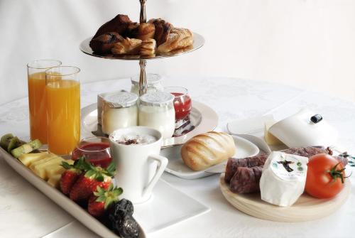 a tray of breakfast foods and drinks on a table at Molino de Alcuneza Relais & Châteaux in Sigüenza