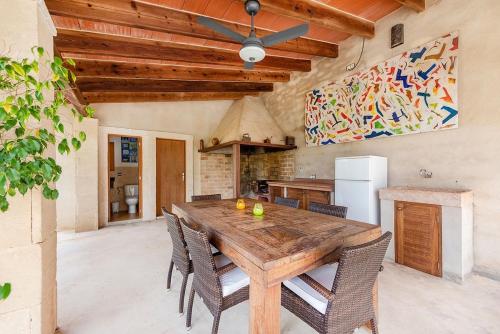 a dining room with a wooden table and chairs at Villa - Sun and Moutain, Sa Murtera in Campanet