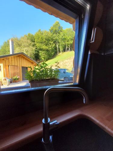 a window in a train looking out at a house at RALPH Cabin- Apuseni Mountains, Transylvania in Bucium