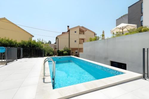 a swimming pool in the backyard of a house at Fides Stylish Apartments Tivat with Pool in Tivat