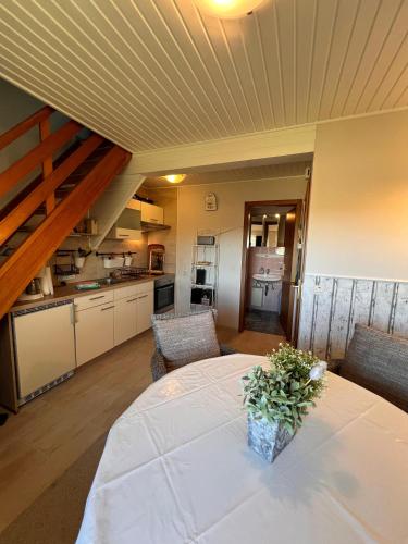 a kitchen and a table with a vase on it at Möwenkiek in Nordstrand