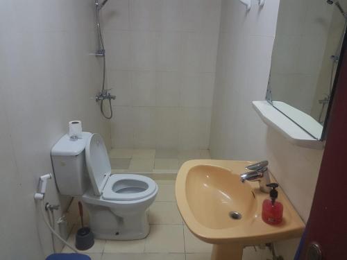 a small bathroom with a toilet and a sink at BONITA Al Ain in Al Ain