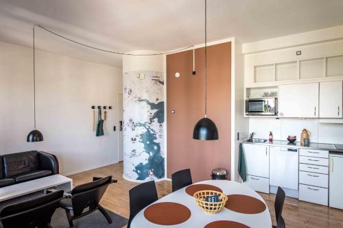 a kitchen and dining room with a table and chairs at Kolding Hotel Apartments in Kolding