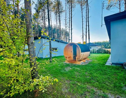 a wooden boat sitting in a yard next to a house at 4REST in Żytno