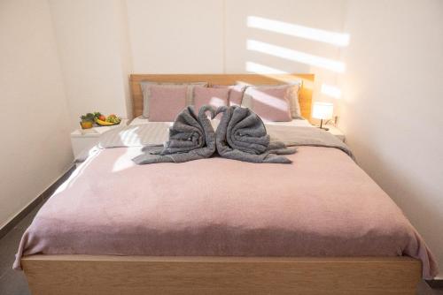 a bed with two towels on top of it at Harmony in Perea