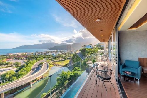 a room with a balcony with a view of the ocean at Anh Nguyen Oceanfront Luxury Villas Nha Trang in Nha Trang