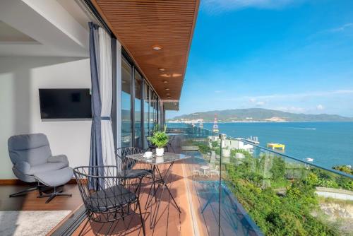a balcony with chairs and a view of the ocean at Anh Nguyen Oceanfront Luxury Villas Nha Trang in Nha Trang