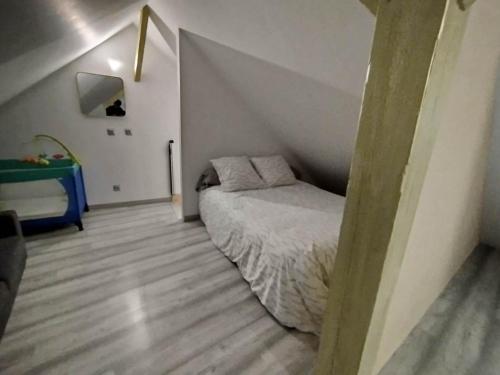 a small bedroom with a bed in a attic at maison luxe cléo aeroport tillé 4 personnes in Tillé