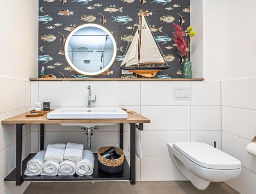a bathroom with a sink and a mirror at Fjord-Koje 6 in Schleswig