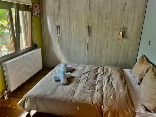 a bed with two teddy bears on top of it at Chalet Dirfys - Escape in the heart of Evia in Kambiá