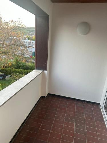 an empty room with a window and a tiled floor at Wohnung Remshalden Grunbach in Remshalden