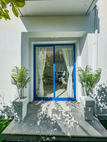 a blue door of a house with two potted plants at Diana HATS 1B, Pool, Paphos Center in Paphos City