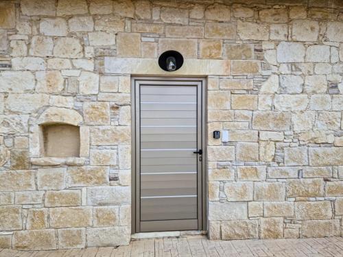 a stone wall with a door in front of it at Andre Marie Stonewood Retreat in Limassol