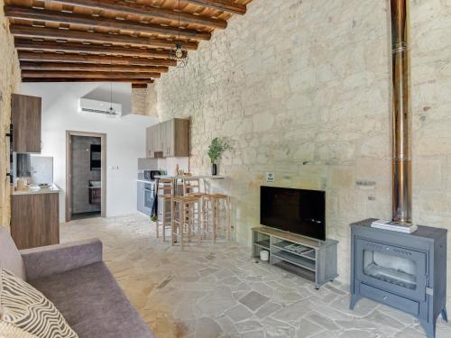 a living room with a tv and a fireplace at Andre Marie Stonewood Retreat in Limassol