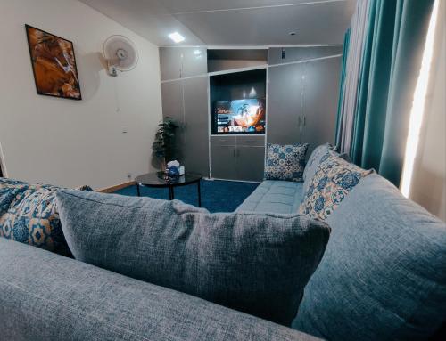 a living room with a couch and a tv at QB Sunset view Villa Bahria Town in Rawalpindi