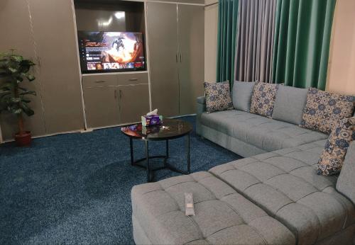 a living room with a couch and a table at QB Sunset view Villa Bahria Town in Rawalpindi