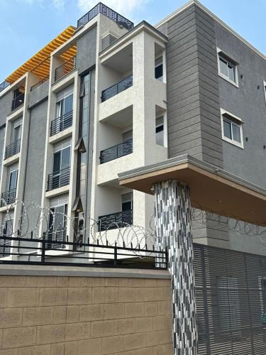 a large apartment building with a pole in front of it at Livluxe Apartments 6 in Kampala