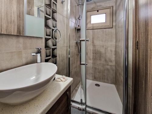 a bathroom with a sink and a shower at Andre Marie Stonewood Retreat in Limassol