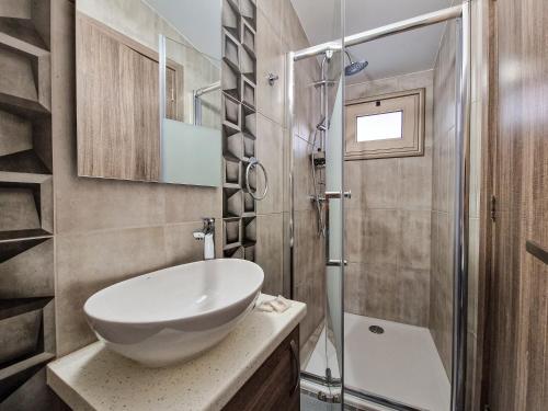 a bathroom with a sink and a shower at Andre Marie Stonewood Retreat in Limassol