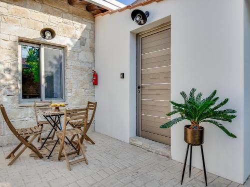 a patio with a door and a table and chairs at Andre Marie Stonewood Retreat in Limassol