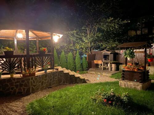 a garden at night with a gazebo at Chez Marcel Sinaia in Sinaia