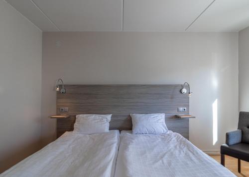 Un ou plusieurs lits dans un hébergement de l'établissement First Hotel Olofström