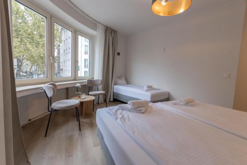 a hotel room with two beds and a window at Hotel Doerenkamp - Digital Access in Düsseldorf
