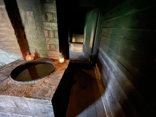 a bathroom with a stone sink with two candles at Salu Jahimaja in Soontaga