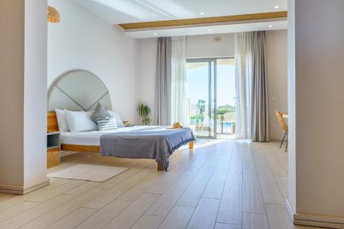 a bedroom with a bed and a large window at Villa dei Venti in Qala