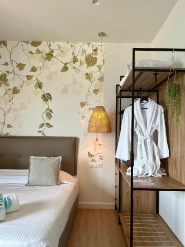 a bedroom with a bed and a wall with flowers at Maritime Suites in Hersonissos