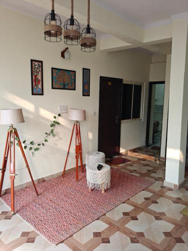 a living room with two lamps and a rug at Mild Life Hostel Rishikesh in Rishīkesh
