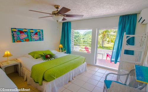 1 dormitorio con cama, ventana y escalera en Greenwood Beach Resort, en Bailey Town