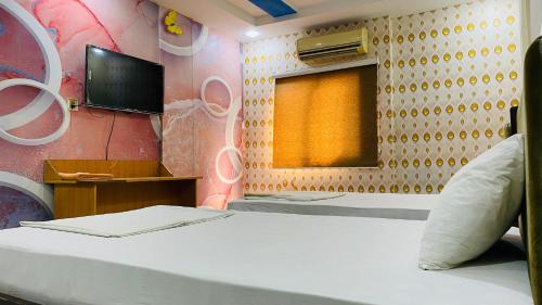 a small room with a bed and a window at The Serena guest House in Hyderabad