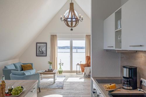 a kitchen and living room with a chandelier at Fjord-Koje 6 in Schleswig