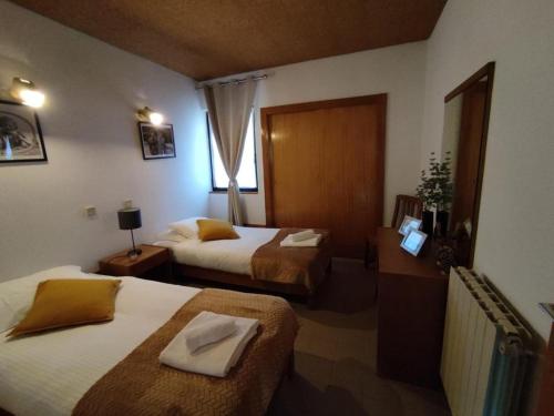 a hotel room with two beds and a window at Special place in São Pedro do Sul in São Pedro do Sul