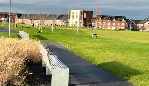 a park with a bench next to a grass field at New House, Private Rooms in a Peaceful Neighborhood in Dublin