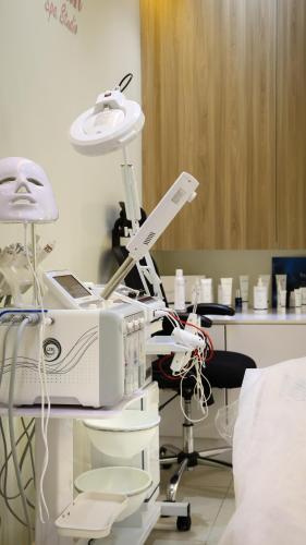 a hospital room with a microscope and a machine at The Myriad Muscat - Female Only ذا ميرياد مسقط - للنساء فقط in Seeb