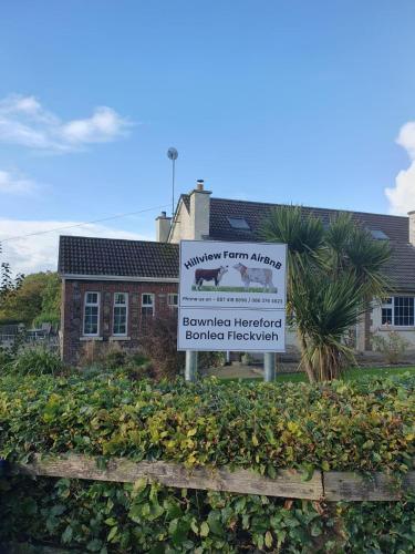 a sign in front of a building at Tranquil countryside farmhouse stay in Thurles