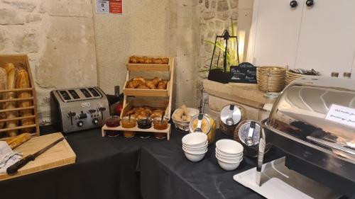 a table with a bunch of pastries on it at La Maison de Mathilde in Bayeux