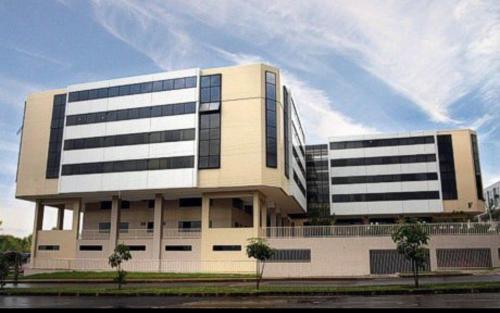 a large white building with black windows at Kit 122 Brasília in Brasilia
